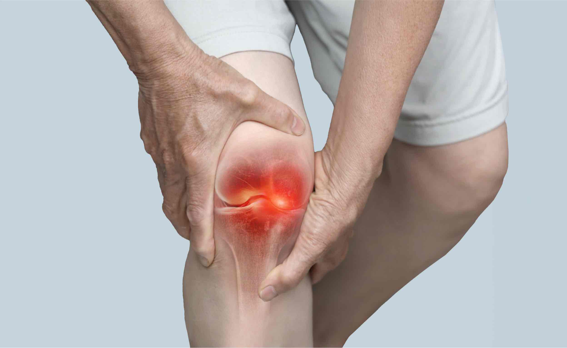 Man holding his knee in pain while standing, close-up of the knee (knee arthritis)